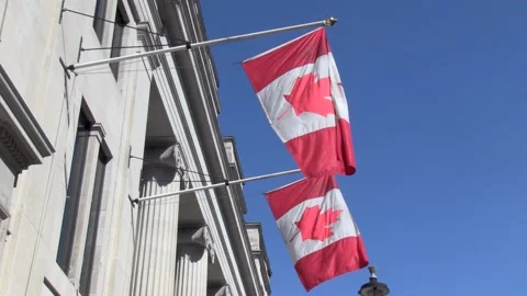 Two Canadian Flags Fly Outside Embassy Stock Footage 136847090