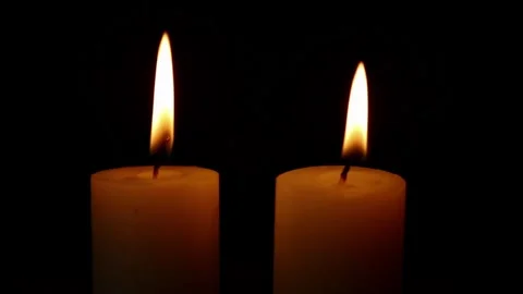Two candle flames blown out in dark silence Stock Footage 323340857