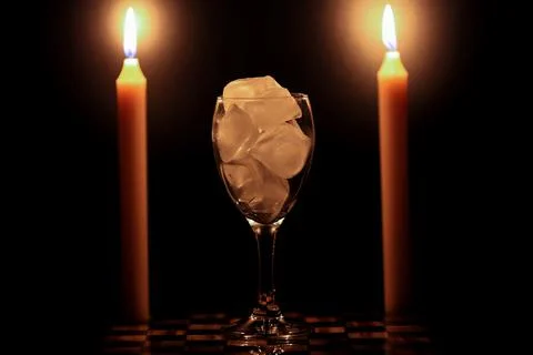 Two candles and a ice Stock Photos