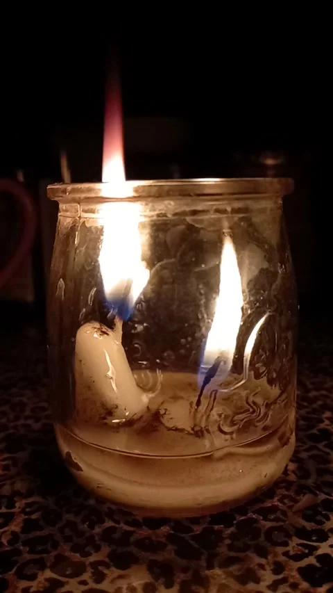 Two candles approaching complete melting Stock Footage 241901937