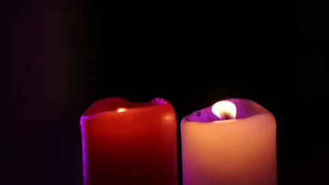 Two candles are burning in a dark room, swaying in the wind Stock Footage 219851154