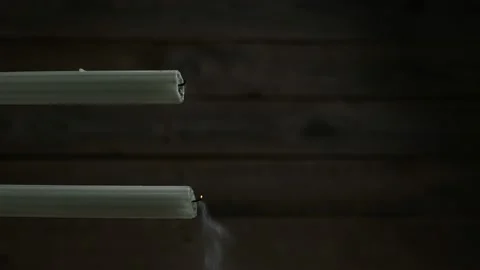 Two candles blow out on dark background Vídeo Stock 232771014
