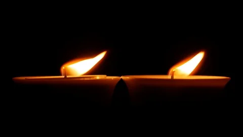 Two candles burn and then someone blows them out Stock Footage 122767583