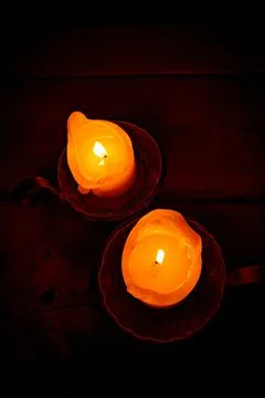 Two candles in the medieval interior. Stock Photos