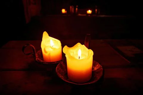 Two candles in the medieval interior. Stock Photos