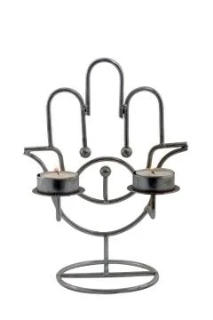 Two candles, which burn in candlestick- hamsa hand against the white backgrou Stock Photos