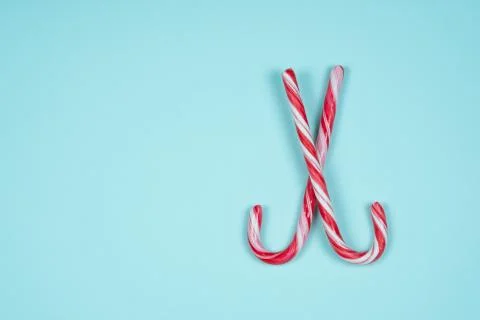 Two candy canes on a light blue background Stock Photos