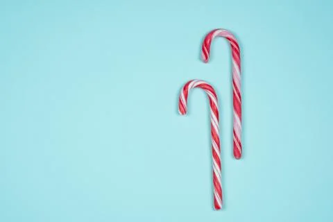 Two candy canes on a light blue background Stock Photos