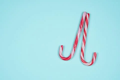 Two candy canes on a light blue background Stock Photos