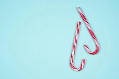 Two candy canes on a light blue background Stock Photos