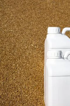 Two canisters stand on grain. The duration of the protective effect of cereals Stock Photos