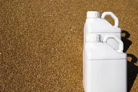 Two canisters stand on grain. The duration of the protective effect of cereals Stock Photos