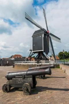 Two cannons and mill Stock Photos