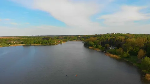 Two canoes float along the lake. floating aerial video drone Stock Footage 107941396