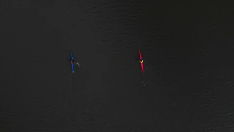 Two canoes float along the lake. floating aerial video drone Stock Footage 107941726