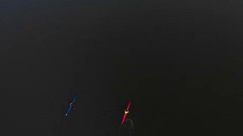 Two canoes float along the lake. floating aerial video drone Stock Footage 107941845