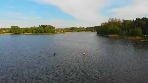 Two canoes float along the lake. floating aerial video drone Stock Footage 107942311