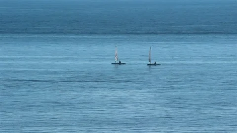 Two Canoes Rowing On Flat Blue Sea. Stock Footage 198170638
