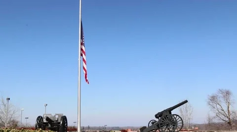 Two Canons Silhouetting US Flag at Half Mast Stock Footage 69223344