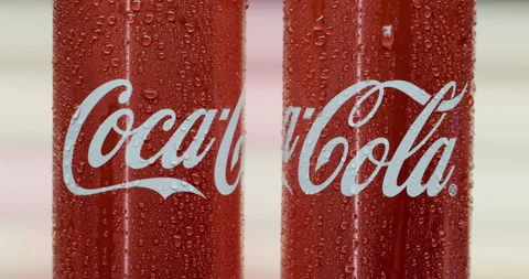 Two cans of Coca-Cola in small drops of water closeup. Stock Footage 144342224