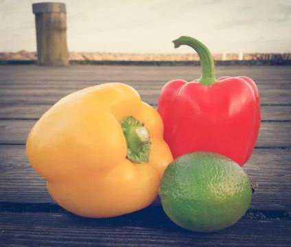 Two capsicums with lemon Stock Photos