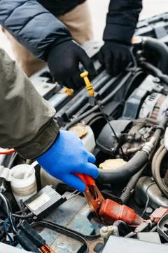 Two Car mechanic engineers checking, fixing the car, making maintenance compr Stock Photos