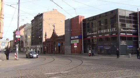 Two-car tram train with a trolley pole slowly turns left Stock Footage 64638992