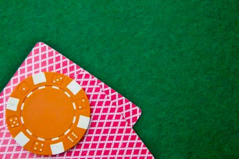 Two cards with faces down with chips on the green table Stock Photos