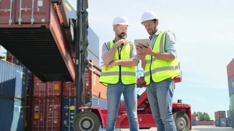 Two cargo container workers or technician men with safety uniform discussion Stock Footage 146441645