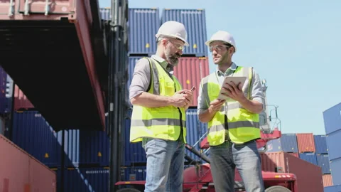 Two cargo container workers or technician men with safety uniform discussion Stock-Footage 146442503