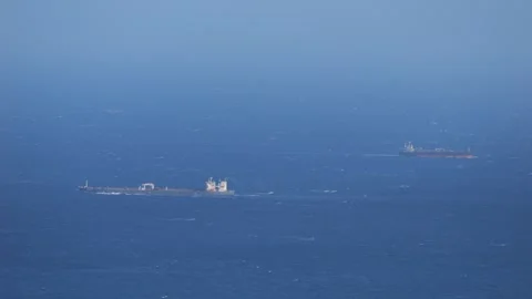 Two Cargo Ships Crossing Open Ocean - Telephoto Maritime Shipping Scene 库存影片 330679594