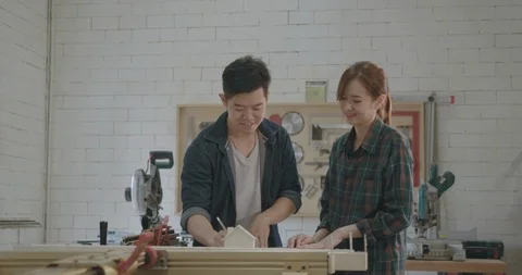 Two carpenter teamwork building design wood house model Stock-Footage 126417901