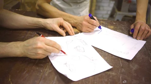 Two carpenters discuss drawing (round wood) in the workshop Stock Footage 102567357