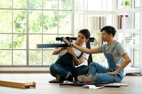Two carpenters discussed the type of bench being assembled. Stock Photos
