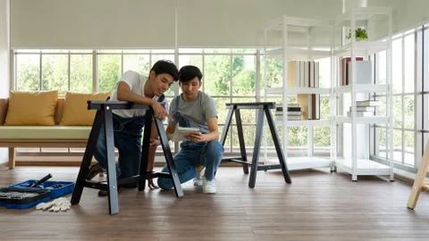 Two carpenters discussed the type of bench being assembled. Stock Photos