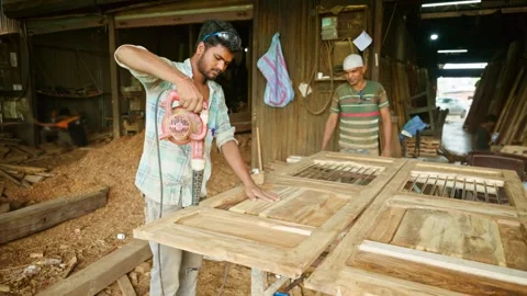 Two carpenters in work shop working with blower Stock Footage 297243106