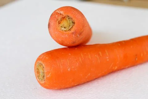 Two carrots on white background which one on top Stock Photos