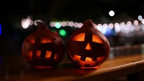 Two carved pumpkins during the halloween celebration at night in the city. Stock Footage 208653404