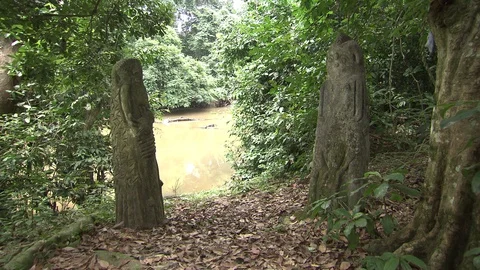 Two carved statues stand pillar at Osun River. Stock Footage 86761070