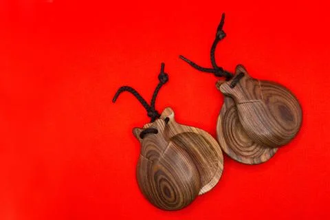 Two castanets are on a red background Stock Photos