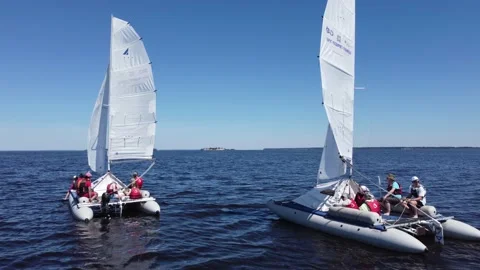 Two catamarans under sail at sea. Blue sky, blue water surface with ripples Stockbeeldmateriaal 197180705