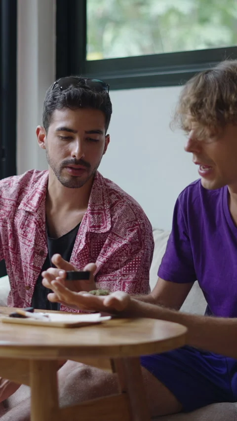Two Caucasian guys preparing a joint Stock Footage 267506890