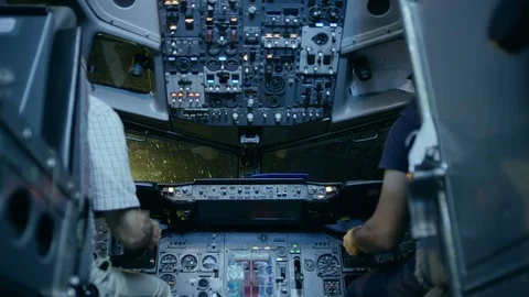 Two Caucasian Male Pilots In The Cockpit Or Flight Deck Of A Passenger Airplane Stock Footage