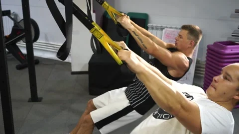 Two caucasian men in the gym doing strength exercises Stock Footage 137082838