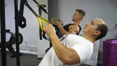 Two caucasian men in the gym doing strength exercises Stock Footage 137082993