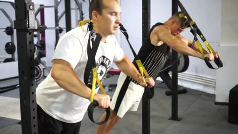 Two caucasian men in the gym doing strength exercises Stock Footage 137083058