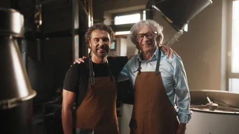 Two Caucasian men standing close to each other while smiling to camera. Younger Stock Footage 315072137