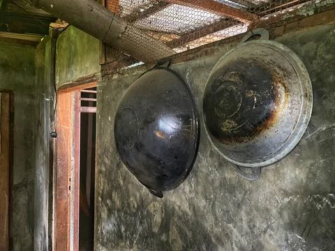 Two cauldrons hung on the wall Stock Photos