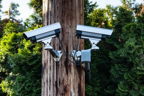 Two cctv security cameras on a pole Stock Photos
