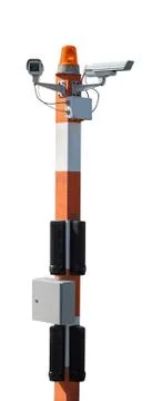 Two CCTV security cameras on red striped pillar with orange flashing light. I Stock Photos